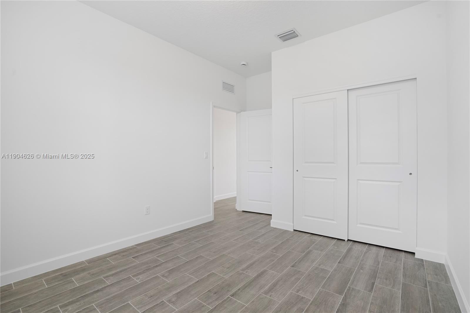 19655 Barn Swallow Way, Unit 19655 West Palm Beach, FL 33470 - Photo 20 of 59 a view of an empty room with wooden floor