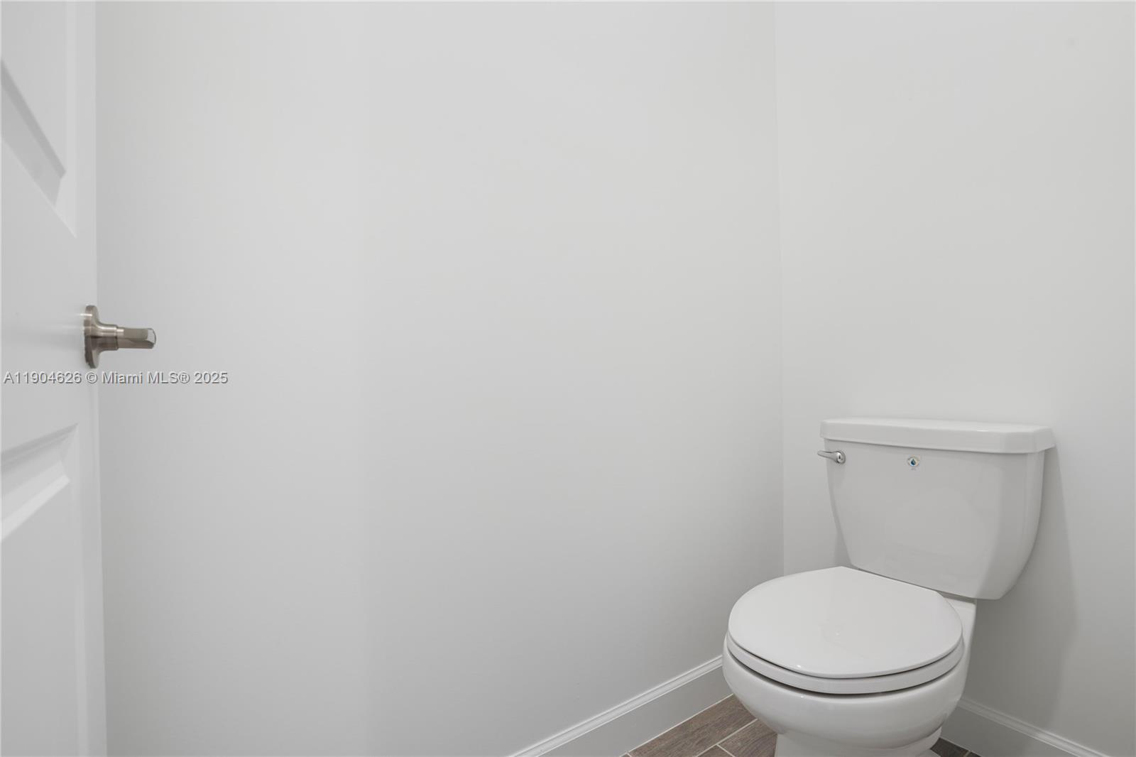 19655 Barn Swallow Way, Unit 19655 West Palm Beach, FL 33470 - Photo 26 of 59 a white toilet sitting next to a white wall