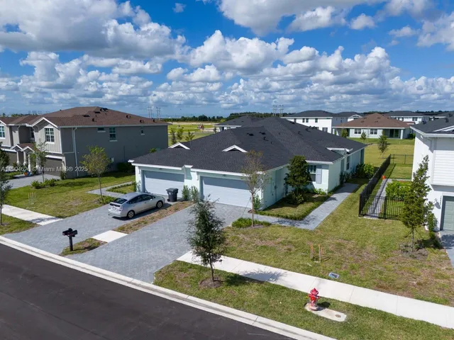 an aerial view of a house with a swimming pool yard and outdoor seating