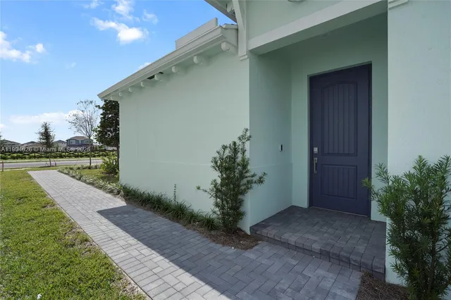 a couple of potted plants in front of door