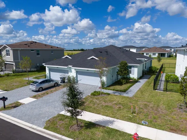 an aerial view of a house with a swimming pool yard and outdoor seating