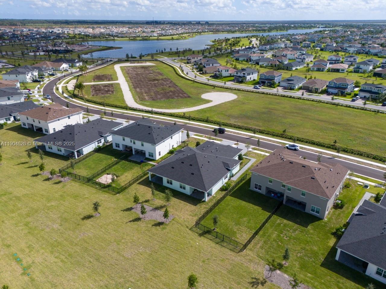 19655 Barn Swallow Way, Unit 19655 West Palm Beach, FL 33470 - Photo 46 of 59 an aerial view of a house with a garden and lake view