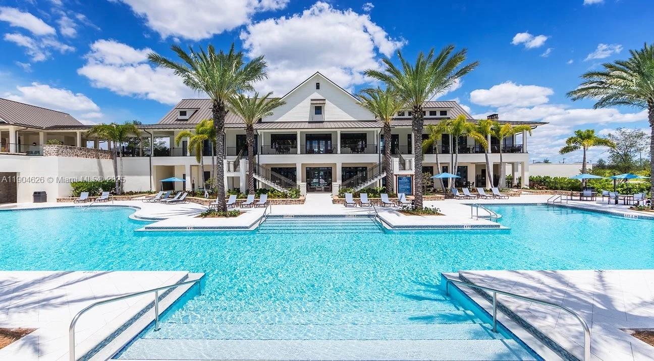 19655 Barn Swallow Way, Unit 19655 West Palm Beach, FL 33470 - Photo 53 of 59 a view of a house with swimming pool yard and sitting area
