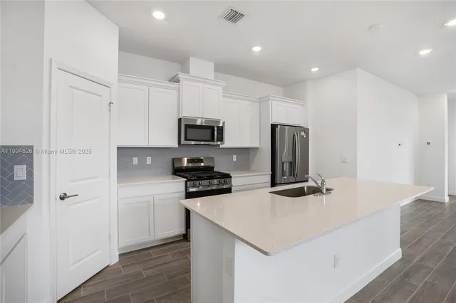 a kitchen with a sink stove and refrigerator