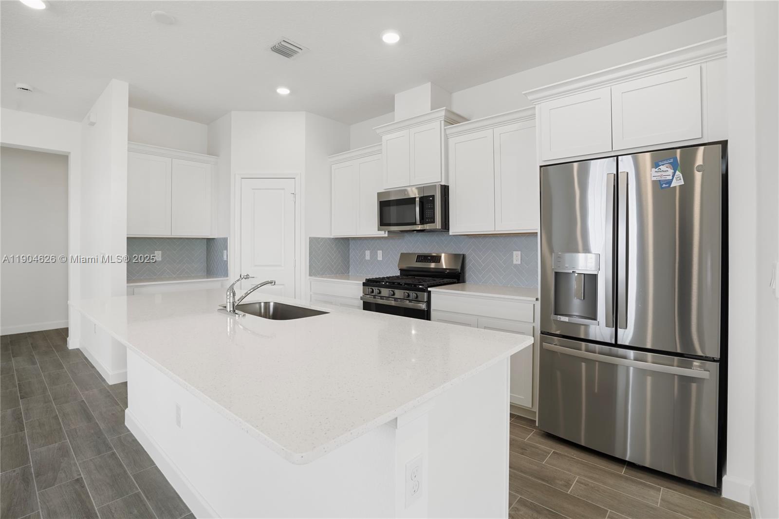 19655 Barn Swallow Way, Unit 19655 West Palm Beach, FL 33470 - Photo 8 of 59 a kitchen with stainless steel appliances a refrigerator stove microwave and sink