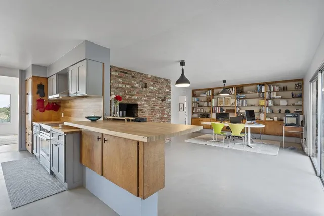a kitchen with granite countertop a sink a stove and cabinets