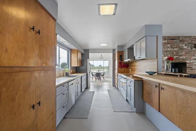 a living room with furniture and a book shelf