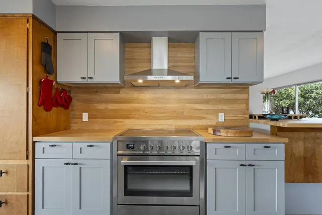 a bed sitting in a bedroom next to a large window