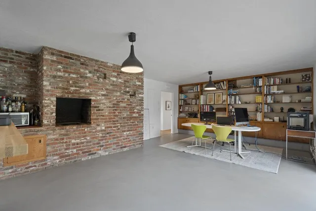 a view of hallway with stairs and wooden floor