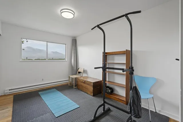 a bedroom with a bed and a painting on the wall