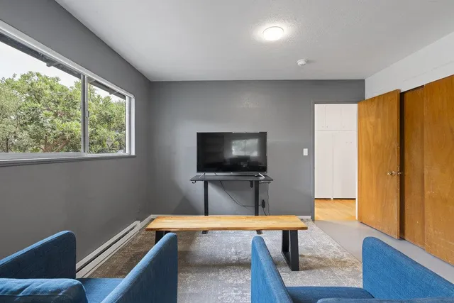 a backyard of a house with table and chairs