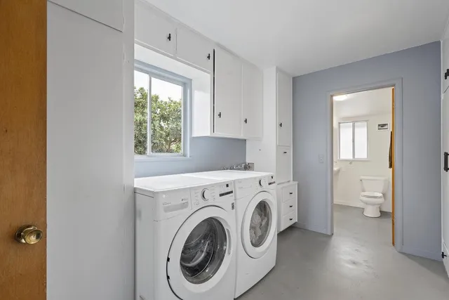 an aerial view of a house with a yard and lake view