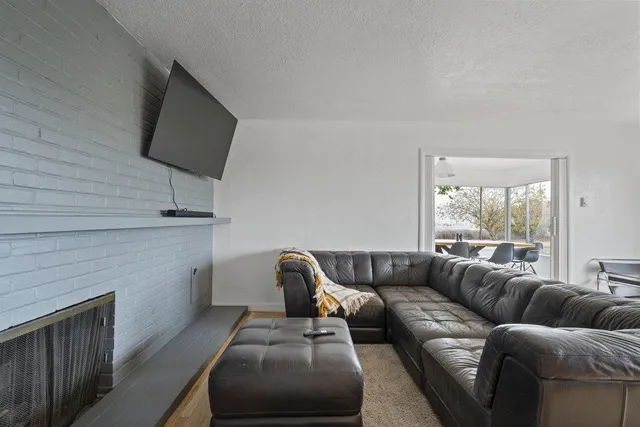 a living room with a large window and a table