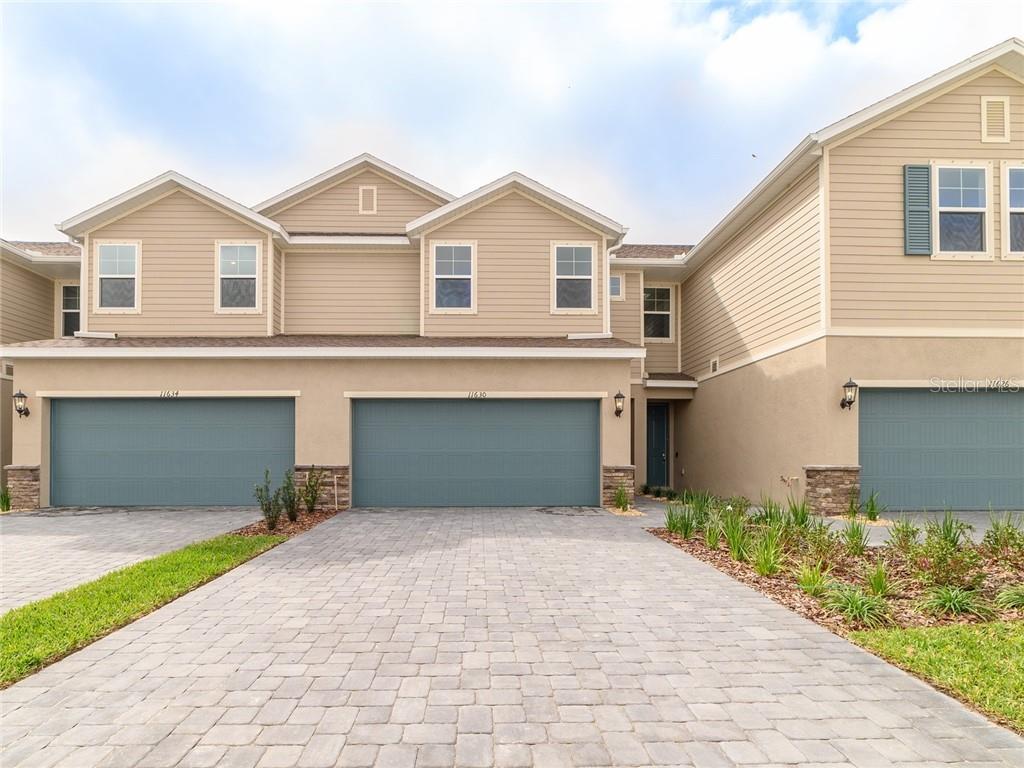 11630 Woodleaf Drive Lakewood Ranch, FL 34211 - Photo 1 of 1 a front view of a house with a yard and garage