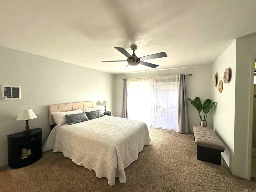 4253 Fifth Avenue San Diego, CA 92103 - Photo 12 of 22 a bedroom with a bed and a chandelier