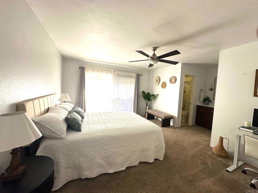 4253 Fifth Avenue San Diego, CA 92103 - Photo 13 of 22 a bedroom with a bed and a chandelier