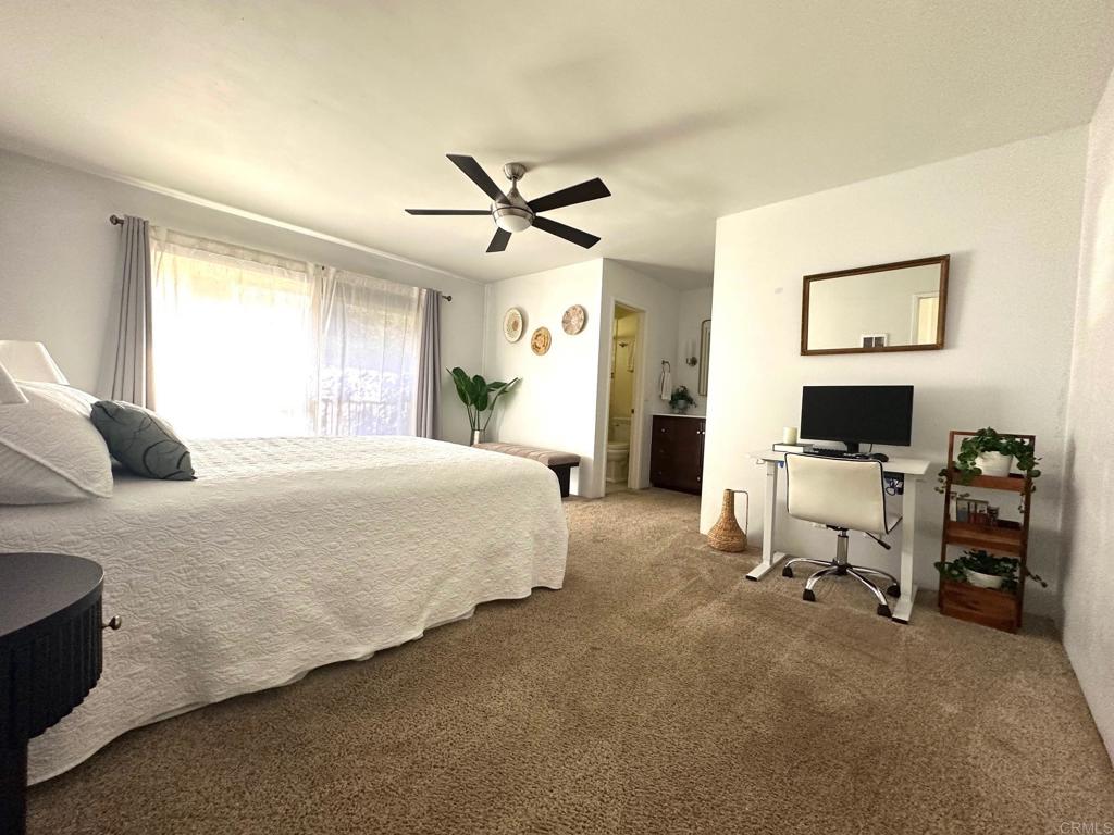 4253 Fifth Avenue San Diego, CA 92103 - Photo 14 of 22 a spacious bedroom with a bed and a chandelier