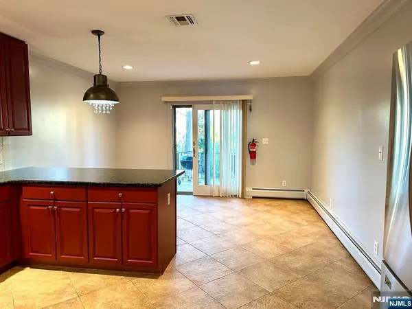 a kitchen with stainless steel appliances granite countertop a stove a sink and a refrigerator with wooden floor