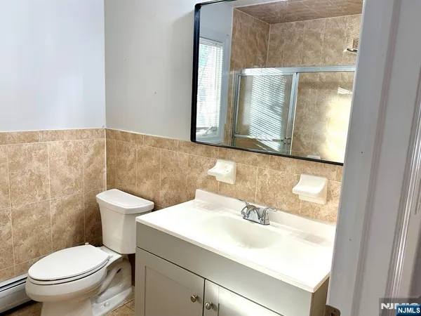 a bathroom with a sink toilet and mirror