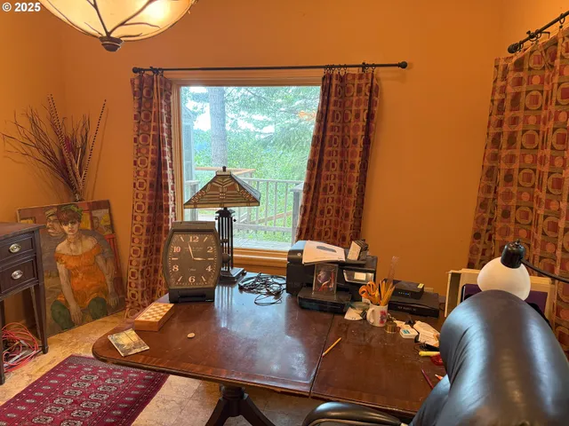 a bedroom with two beds and a large window