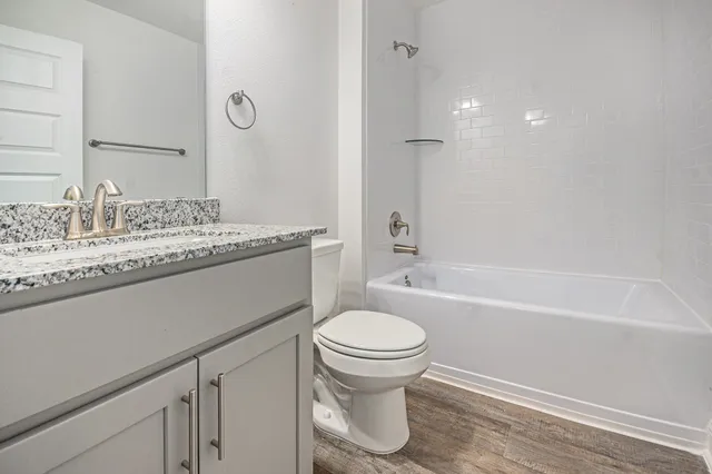 a bathroom with a sink a toilet and a bathtub