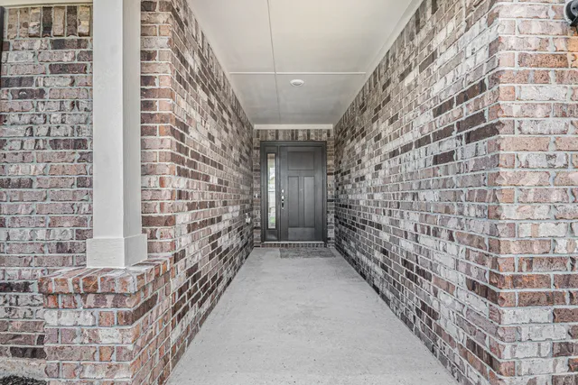 a view of entryway with brick walls