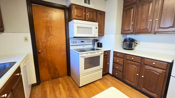 a kitchen with stainless steel appliances white cabinets and a sink