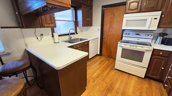 a kitchen with a stove a sink and a refrigerator