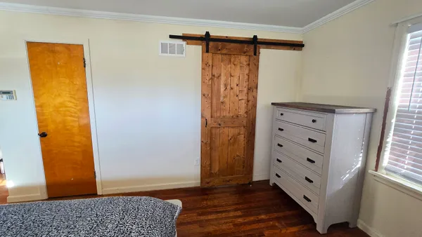 a view of walk in closet with wooden floor