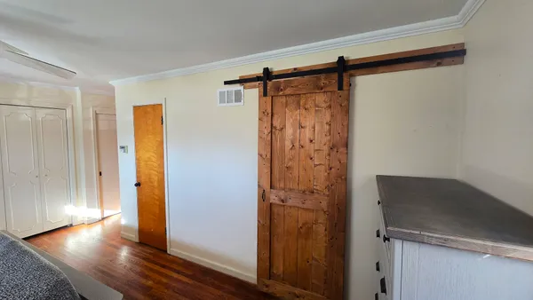 a view of walk in closet with wooden floor