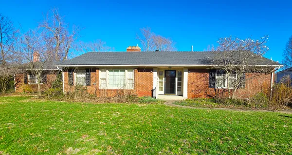 a front view of a house with a yard table and chairs