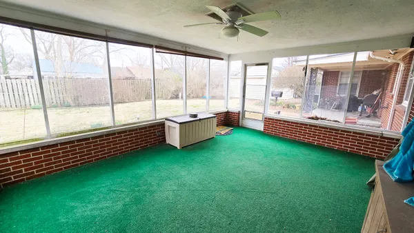 a view of a house with a yard covered with snow
