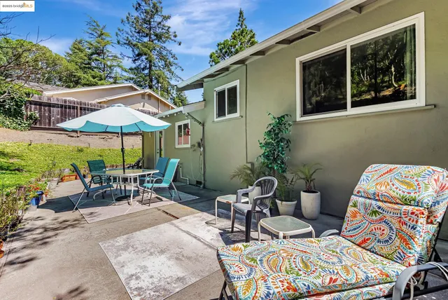a view of an outdoor space with furniture and umbrella