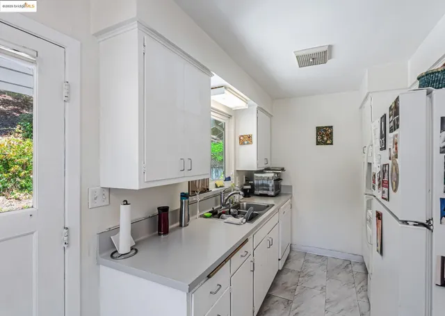 a kitchen with a sink stove and refrigerator