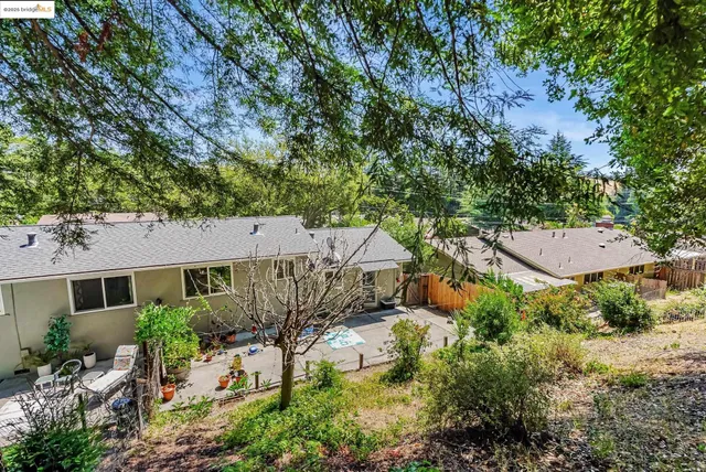 an aerial view of a house with yard and outdoor seating