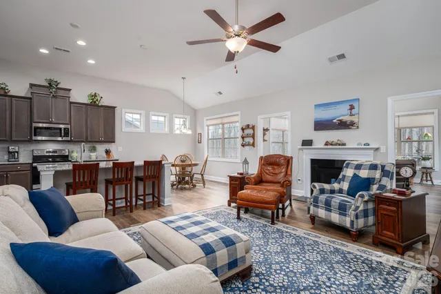 a kitchen with granite countertop a sink a stove and cabinets