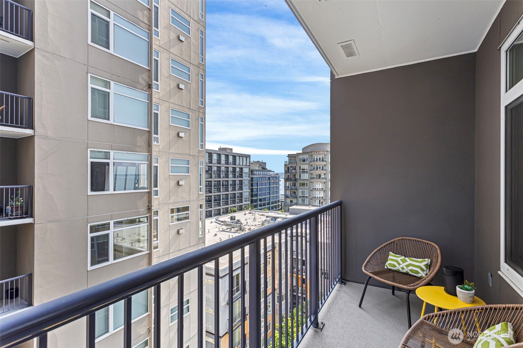 2801 1st Avenue, Unit 612 Seattle, WA 98121 - Photo 6 of 27 a view of a balcony with chairs and a potted plant