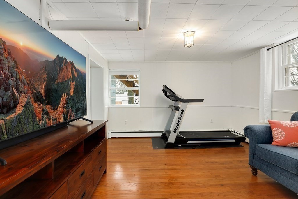 43 Montview Road Chelmsford, MA 01824 - Photo 22 of 40 a room with gym equipment and a flat screen tv