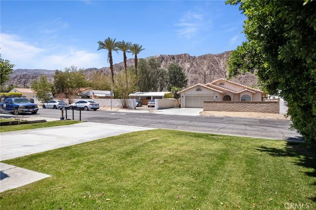 a view of a house with swimming pool and sitting area