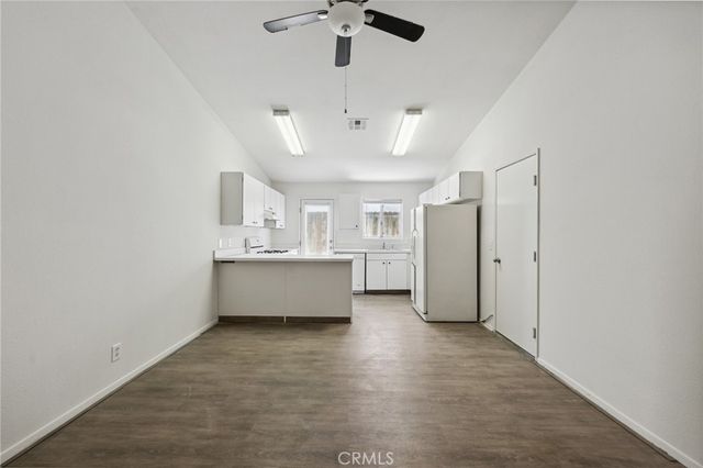 a kitchen with white cabinets and white appliances