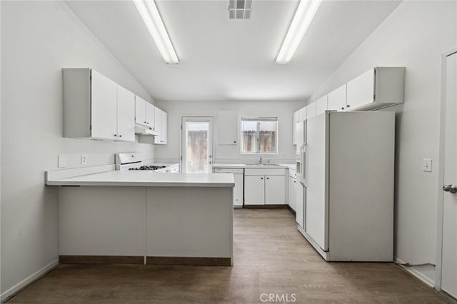 a kitchen with stainless steel appliances a sink stove and refrigerator