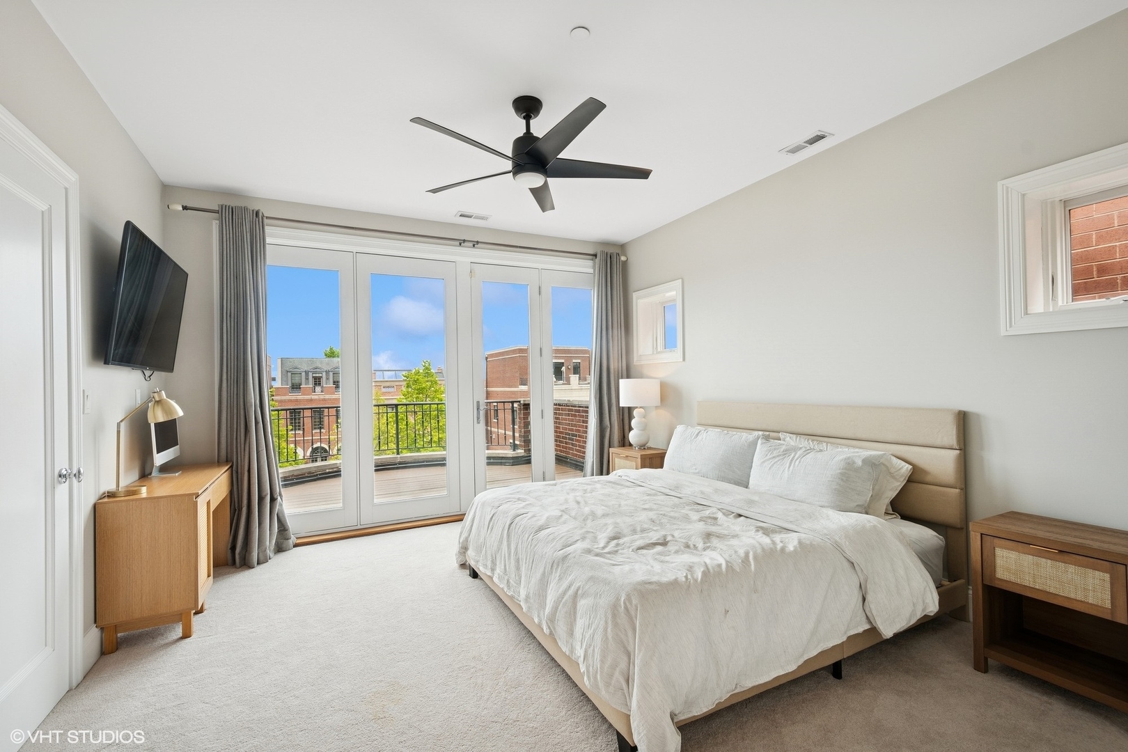 1759 West Surf Street Chicago, IL 60657 - Photo 29 of 43 a bedroom with a large bed and a flat tv screen