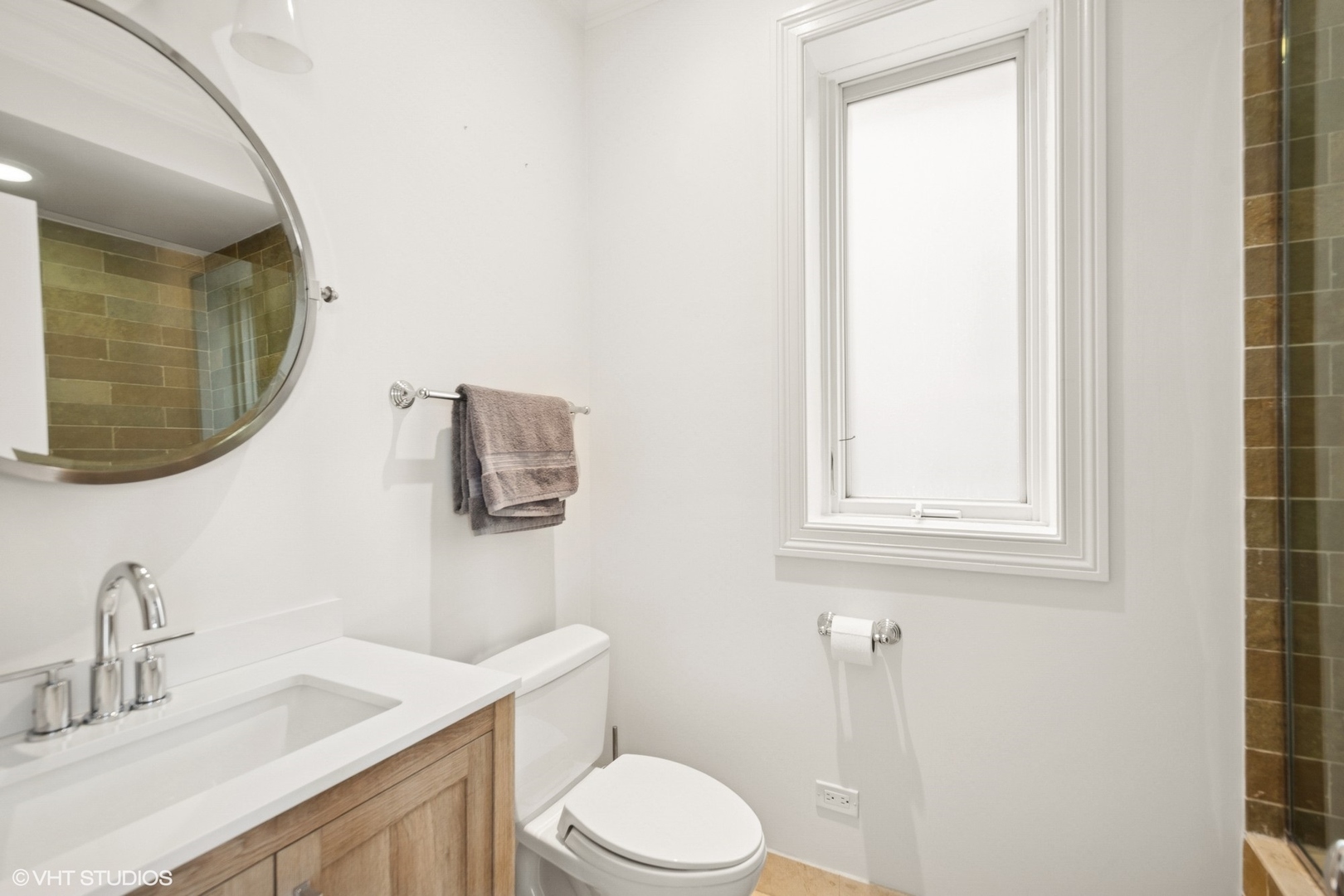 1759 West Surf Street Chicago, IL 60657 - Photo 31 of 43 a bathroom with a toilet sink vanity and mirror