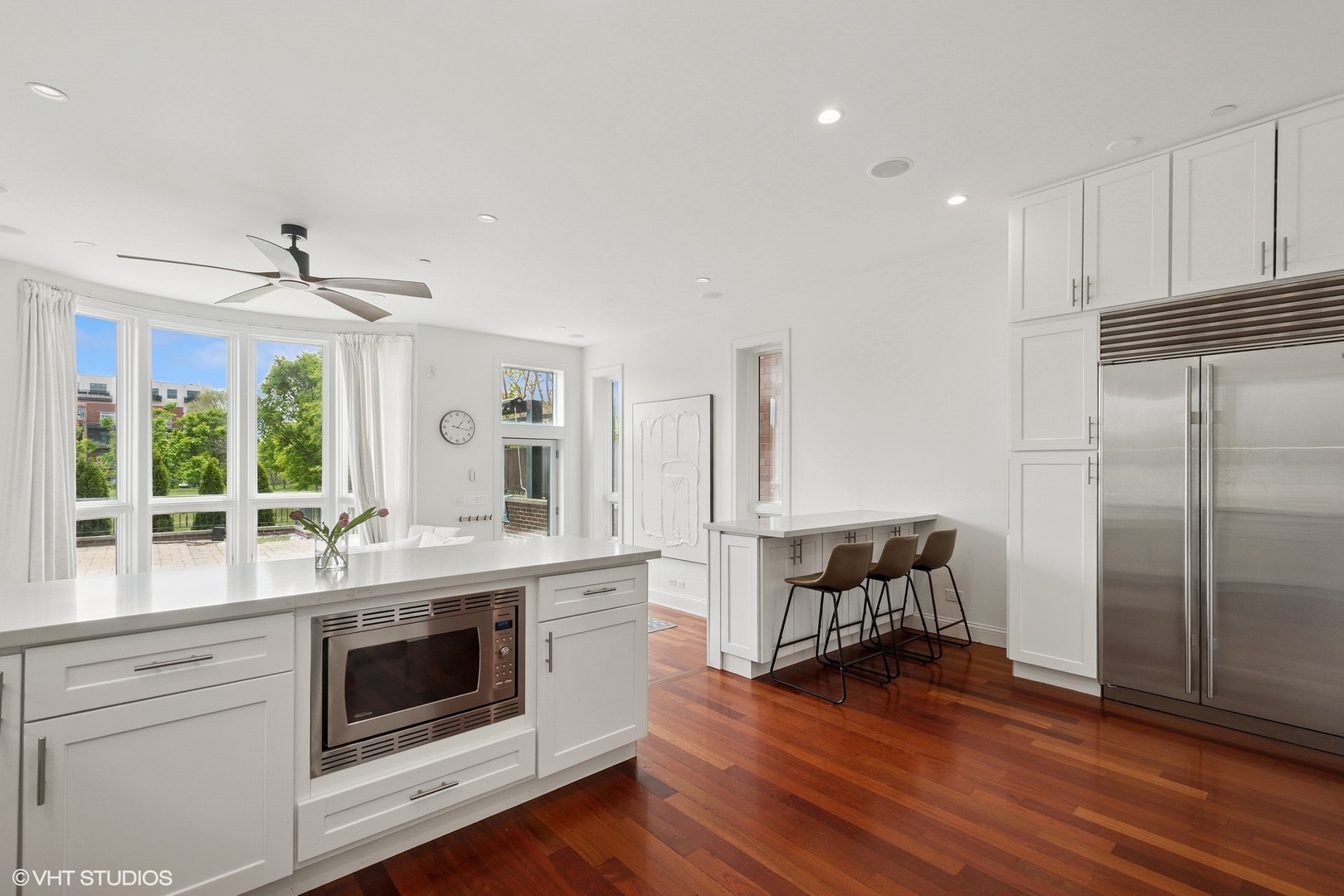 1759 West Surf Street Chicago, IL 60657 - Photo 8 of 43 a kitchen with a refrigerator and white cabinets
