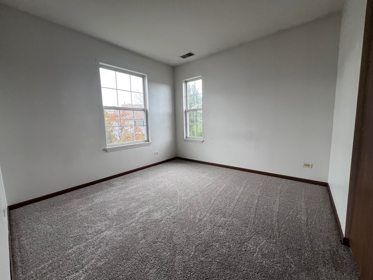 1350 Orleans Drive, Unit 1350 Mundelein, IL 60060 - Photo 17 of 26 an empty room with windows