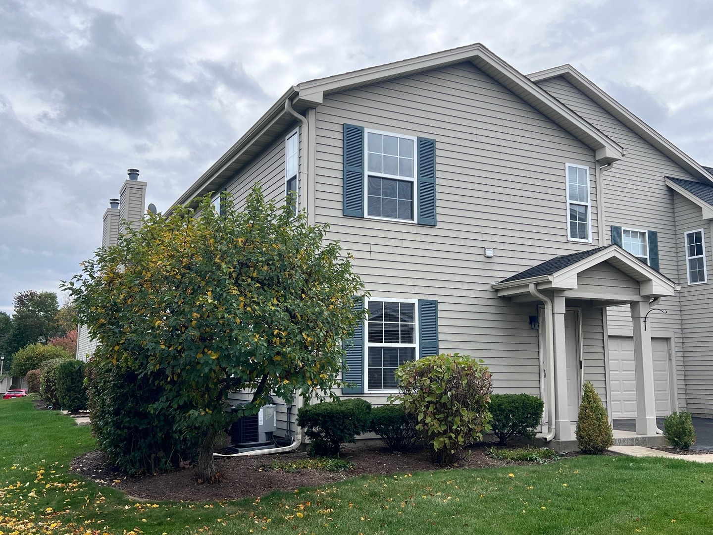 1350 Orleans Drive, Unit 1350 Mundelein, IL 60060 - Photo 2 of 26 a view of a house with a yard and plants