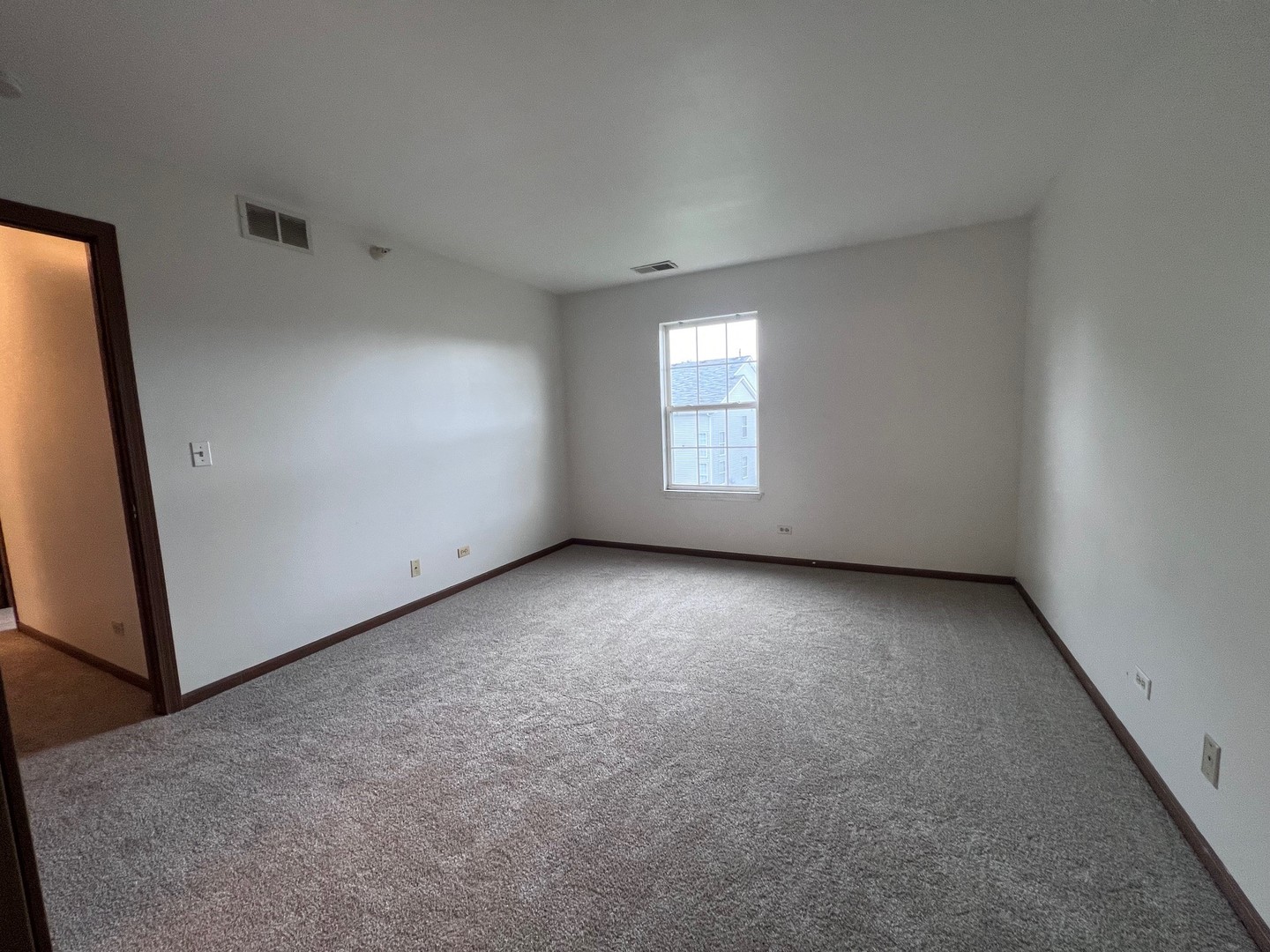 1350 Orleans Drive, Unit 1350 Mundelein, IL 60060 - Photo 23 of 26 an empty room with windows
