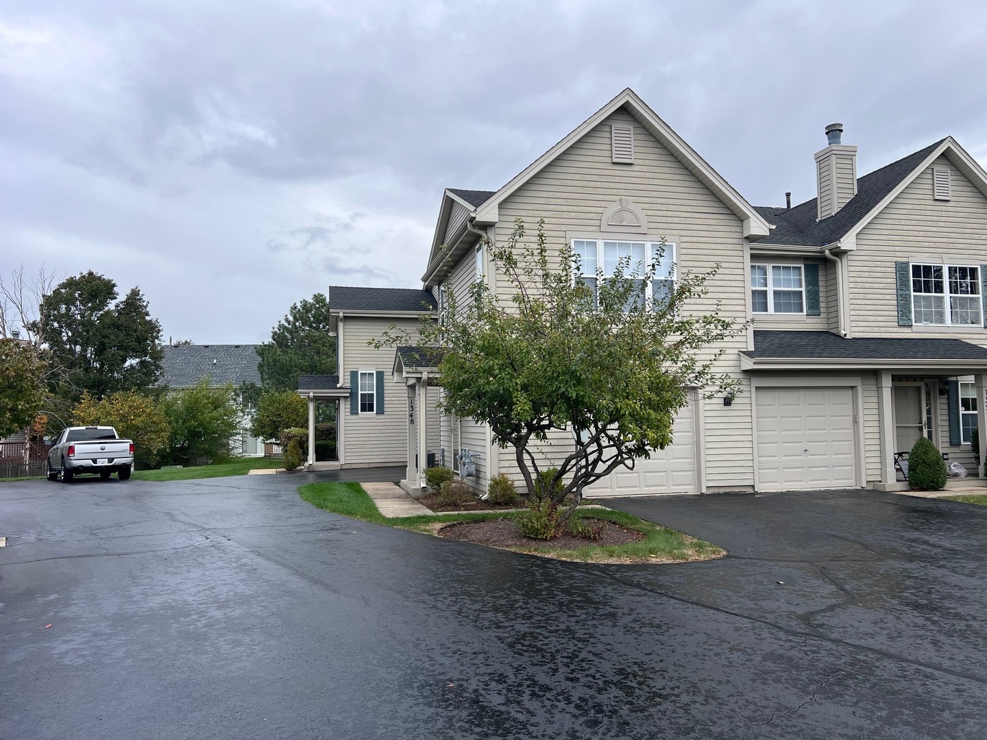 1350 Orleans Drive, Unit 1350 Mundelein, IL 60060 - Photo 26 of 26 a front view of a house with a yard and garage