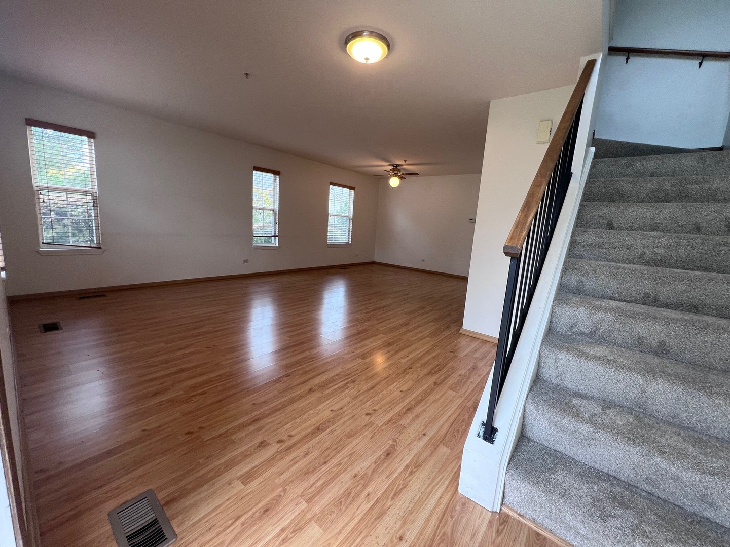 1350 Orleans Drive, Unit 1350 Mundelein, IL 60060 - Photo 6 of 26 wooden floor in an empty room with a window