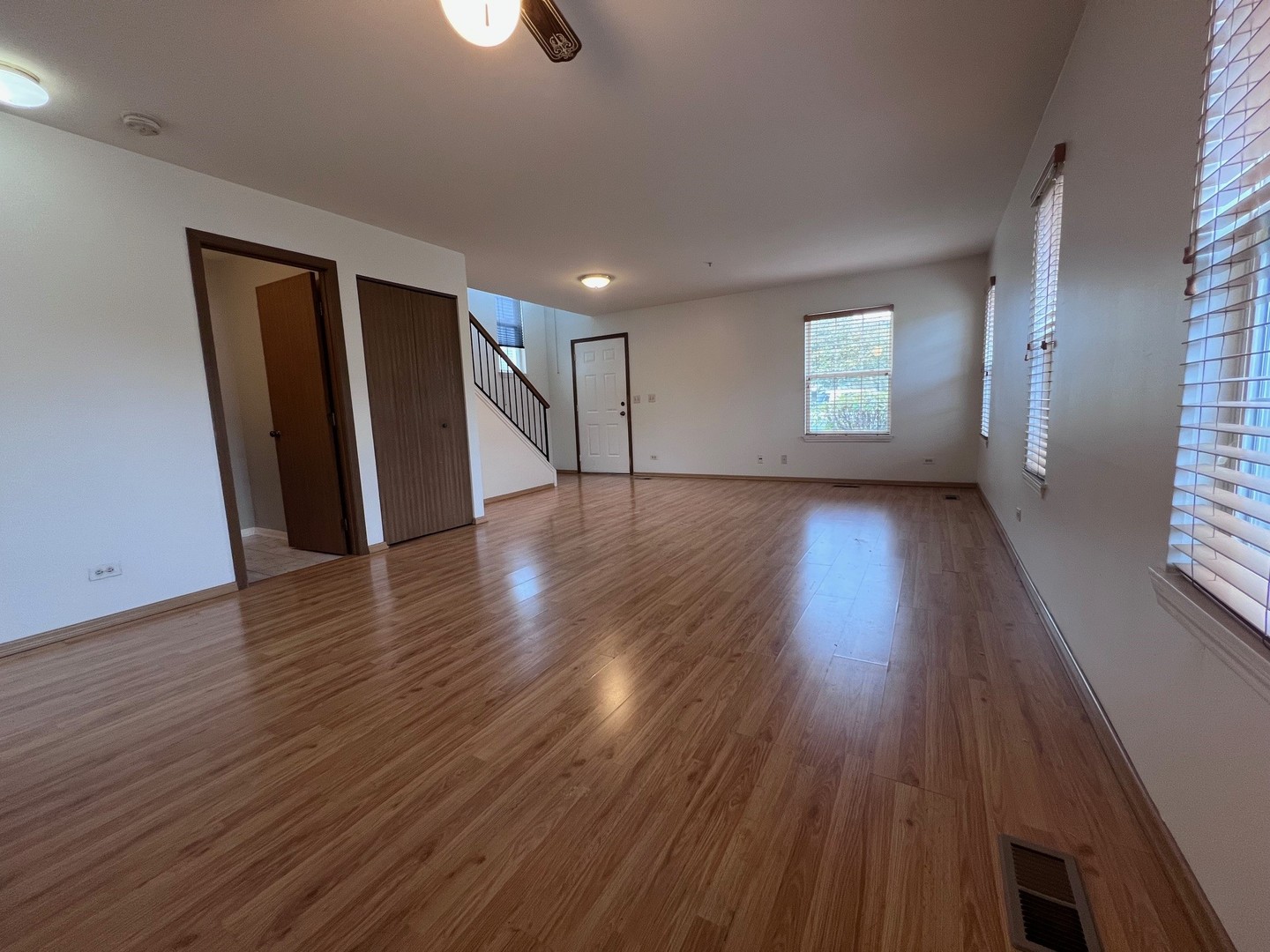 1350 Orleans Drive, Unit 1350 Mundelein, IL 60060 - Photo 7 of 26 an empty room with wooden floor and windows